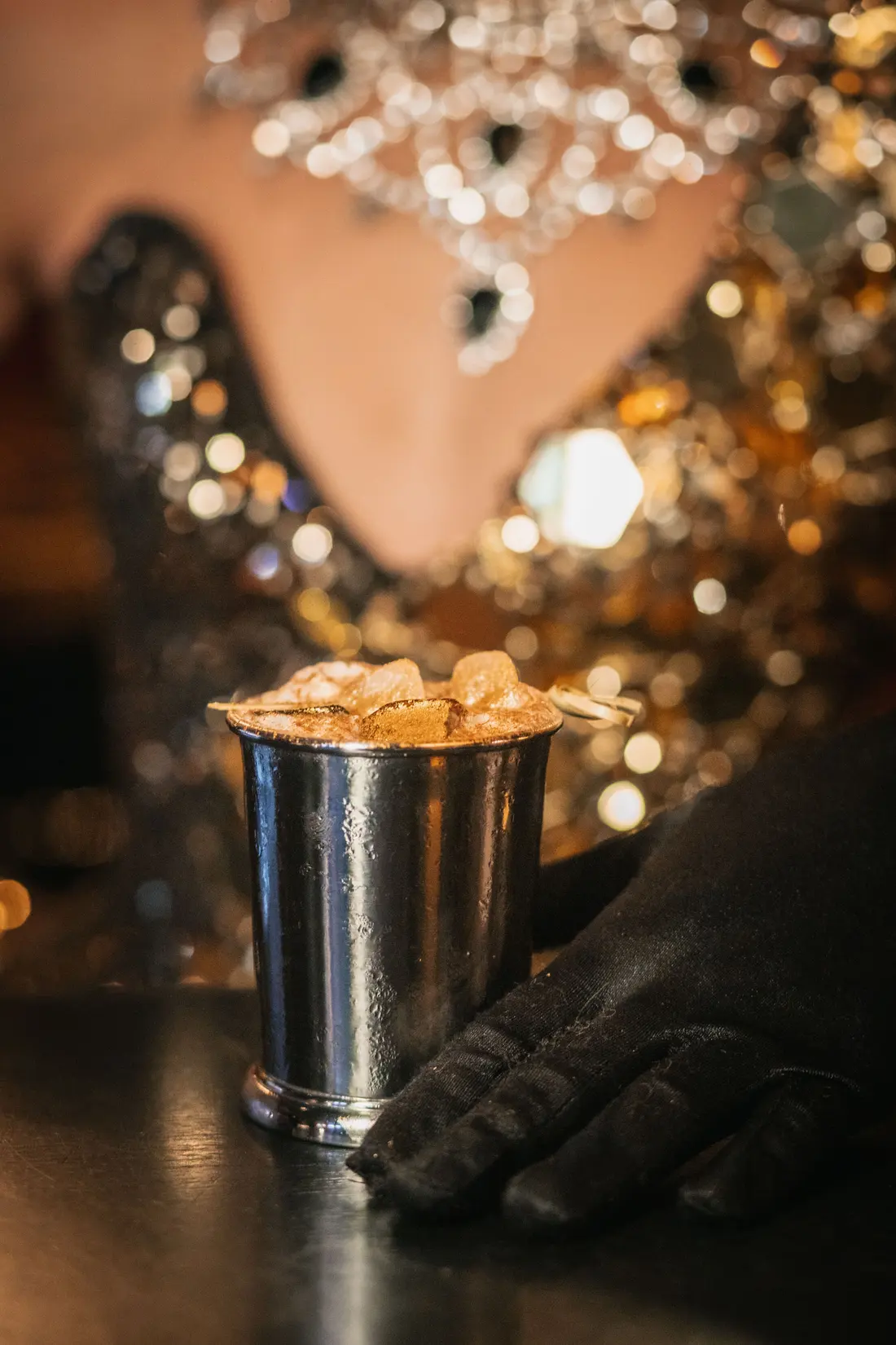 Jewels, black gloves and a silver champagne cooler